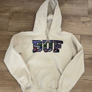 View From the Ralph" unisex hoodie in cream with a stadium graphic size small